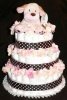 brown polka dot diaper cake with cream flowers and cream dog