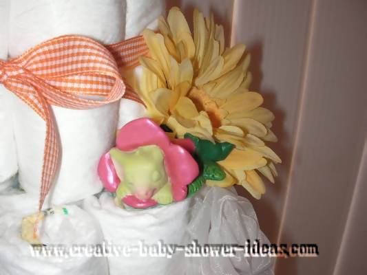 closeup of pocket dragon sleeping on a flower in diaper cake