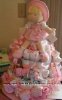 pink doll themed diaper cake with pink ribbon