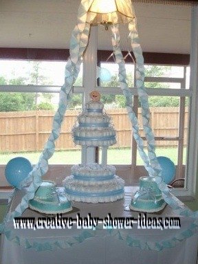 blue and white wedding style diaper cake with baby bootie cakes