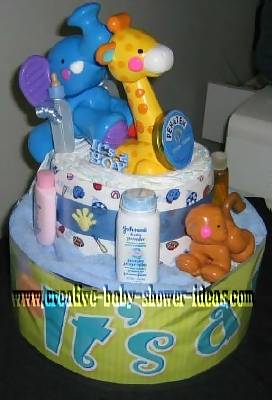 2 tier jungle diaper cake with plastic animals and miniature baby supplies