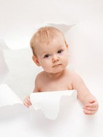 baby ripping through white paper