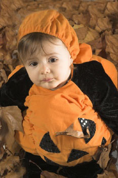 cute baby girl in a pumpkin costume