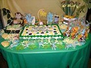 monkey baby shower table display with sheet cake and lots of favors and prizes lined up