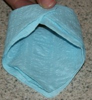 fold napkin sides in and hold