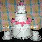 pink and white candle towel cake
