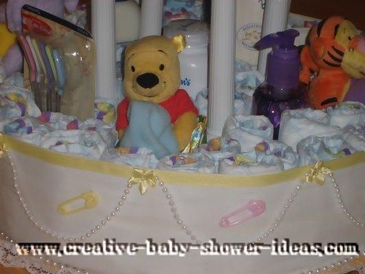 closeup of stuffed animals on winnie the pooh diaper cake