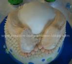 baby bum and feet sticking out of cake like it crashed into the cake
