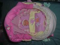 top view of basket baby carriage with doll