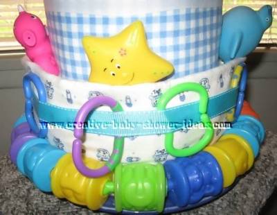 closeup of bottom layer nappy cake with linking toys