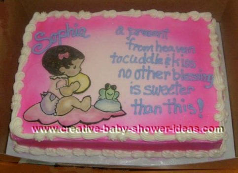 pink baby shower cake with picture of baby sitting on a blanket next to a smiling frog