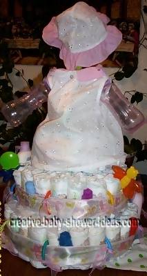 back of sunflower doll diaper cake sitting on 2 tier diaper cake