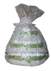 white diaper cake with green ribbon wrapped in white tulle
