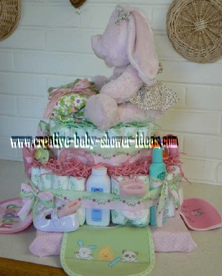 side of pink bunny diaper cake showing bibs