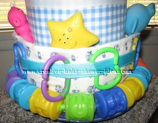 closeup of bottom layer nappy cake with linking toys