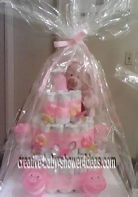 finished pink teddy bear diaper cake wrapped in cellophane