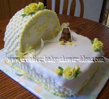 yellow and white baby shower bassinet cake