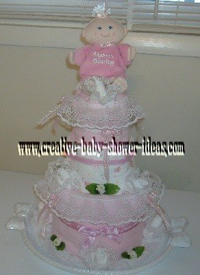 pink doll and lace diaper cake