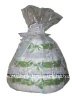 white diaper cake with green ribbon wrapped in white tulle