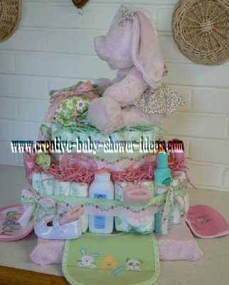 side of pink bunny diaper cake showing bibs
