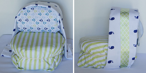 blue and green diaper baby carriage with whales and stripes attaching sun shade on diaper stroller