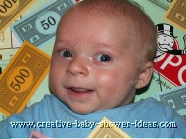 baby smiling laying on a monopoly board game