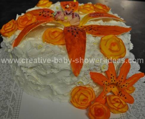 elegant cream baby cake with baby sleeping on orange flowers