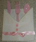 napkin folded into a baby shirt 