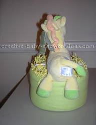 back of green and yellow giraffe diaper cake