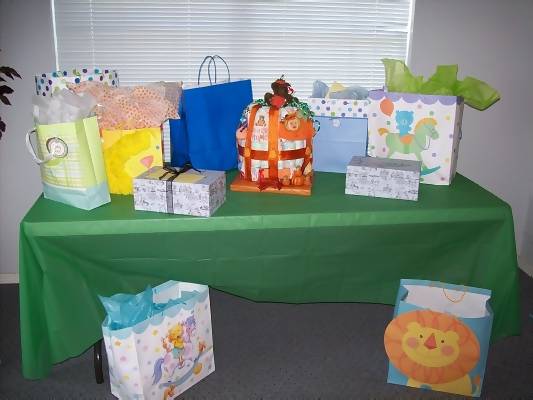pumpkin diaper cake on gift table at baby shower