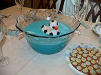 picture of baby food table with blue punch and a sports rubber duck floating in the punch