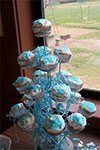 cupcake stand with white cupcakes and blue sprikles