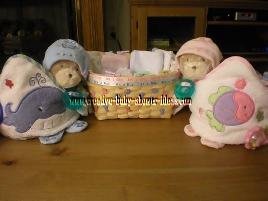 finised towel cupcakes with basket full of baby supplies